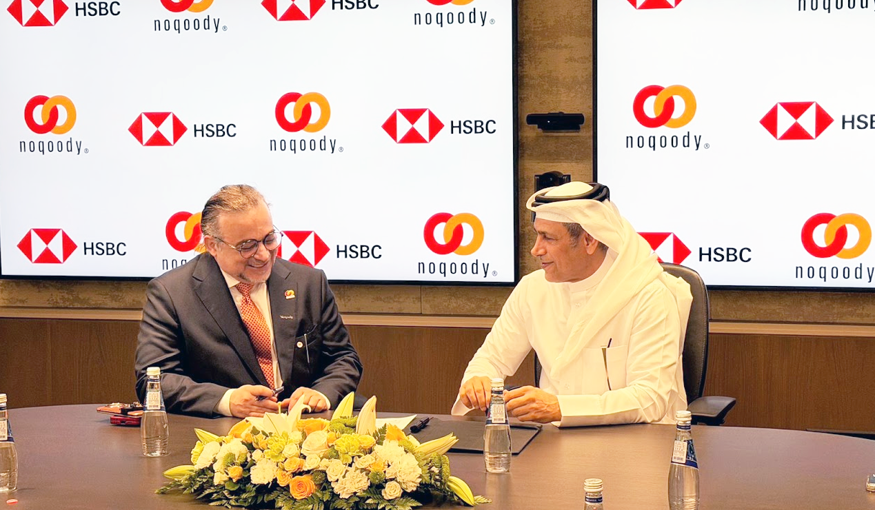 Noqoody and HSBC executives at the strategic partnership signing ceremony in Doha, in front of a backdrop of HSBC and Noqoody logos